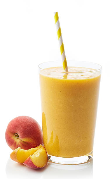 Glass of peach smoothie Glass of fresh healthy peach smoothie isolated on white background peach smoothie stock pictures, royalty-free photos & images