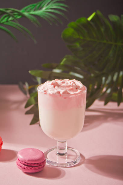 Glass of rose or strawberry iced Dalgona whipped drink coffee stock photo