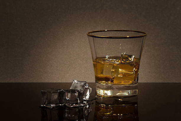 glass of whiskey on a glass table stock photo