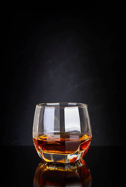 Glass of whiskey on dark background. Glass of whiskey on dark background. rum stock pictures, royalty-free photos & images