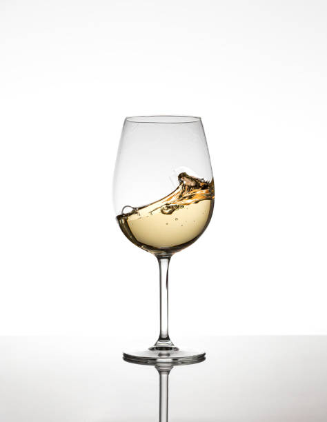 A glass of white wine on the move stock photo
