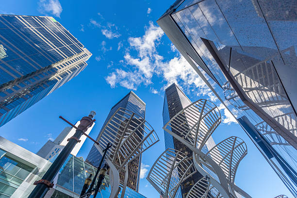 Glass Skyscrapers Street Scene in Calgary modern glass skyscrapers as viewed from street level. calgary stock pictures, royalty-free photos & images