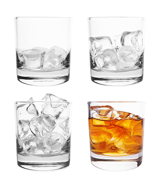 Glass with ice Glass of scotch whiskey and ice on a white background highball glass stock pictures, royalty-free photos & images