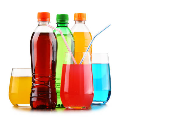 Glasses and bottles of assorted carbonated soft drinks stock photo