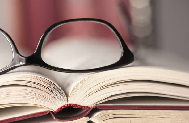 Glasses are laying on a book stock photo