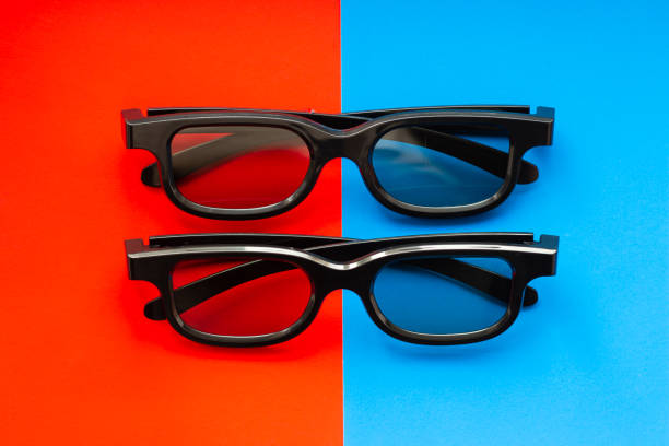 3D glasses for watching movies in the cinema and at home 3D glasses for watching movies in the cinema and at home on a red-blue background close up, two pairs of black 3D glasses 3 d glasses stock pictures, royalty-free photos & images