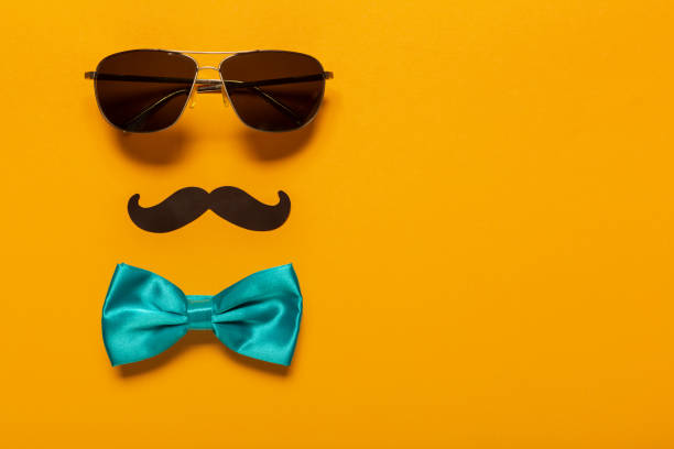 Glasses, mustache, and blue bow as a symbol of father's day with free space for text, greeting card for holiday. stock photo