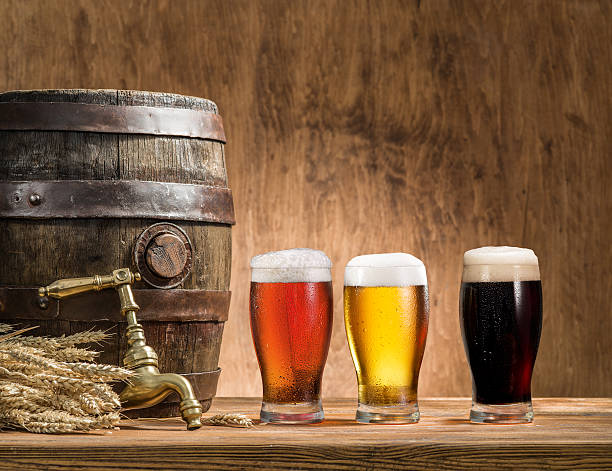 Glasses of  beer and ale barrel on the wooden table. Glasses of  beer and ale barrel on the wooden table. Craft brewery. artisanal food and drink stock pictures, royalty-free photos & images
