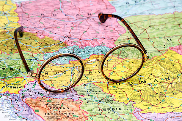 Photo of glasses on a map of europe. Focus on Hungary. May be used as...