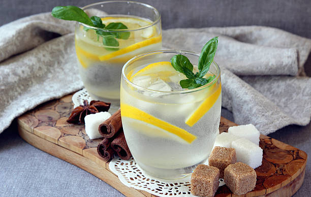 Glasses with cold lemonade and ice cubes stock photo
