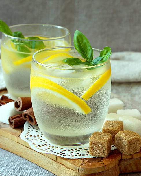 Glasses with cold lemonade and ice cubes stock photo