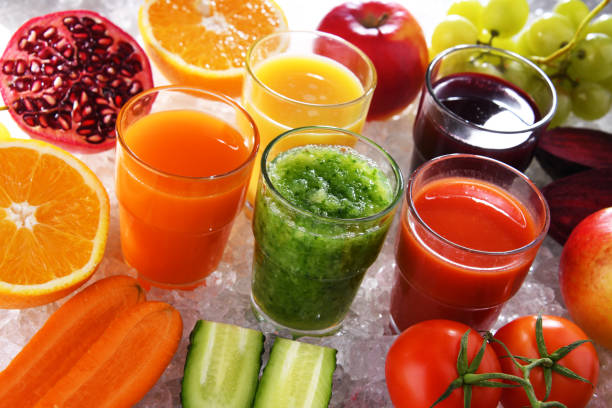 Glasses with fresh organic vegetable and fruit juices stock photo