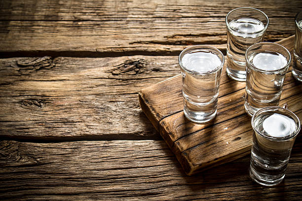 Glasses with vodka on the old Board. Glasses with vodka on the old Board. On wooden background. vodka stock pictures, royalty-free photos & images