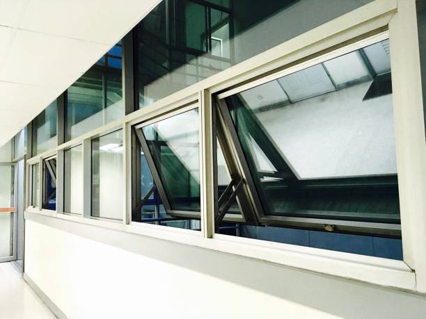 Glazed Aluminium Awning Windows Open in The Morning Glazed Aluminium Awning Windows Frame Open in The Morning for Bright Light Streaming Through The Room. awning window stock pictures, royalty-free photos & images