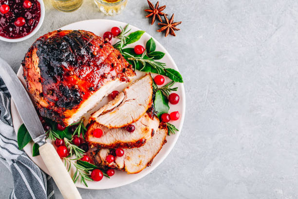 Glazed Ham with cranberry sauce. Roasted Holiday Pork with spices. Top view. Glazed Ham with cranberry sauce. Roasted Holiday Pork with spices. Top view, copy space. ham stock pictures, royalty-free photos & images