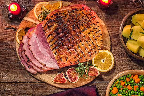 Glazed Holiday Ham with Cloves Background Glazed Holiday Ham with Cloves Background ham stock pictures, royalty-free photos & images