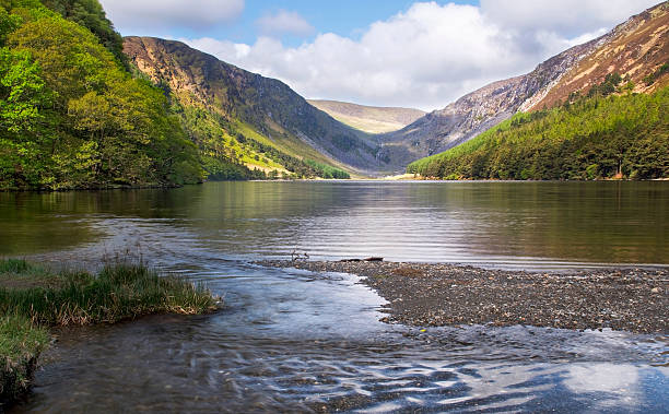 Glendalough upper lake lit up by the sun, ireland Continuing on the wicklow way i passed the upper lake once more. Beautiful.  killarney ireland stock pictures, royalty-free photos & images