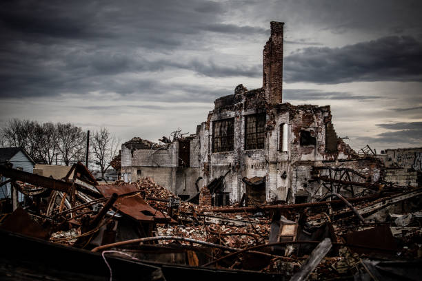 Gloomy photo of a collapsing brick industrial building left abandoned stock photo