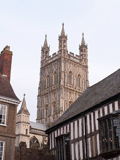 Gloucester cathedral rising above old rooftops stock photo