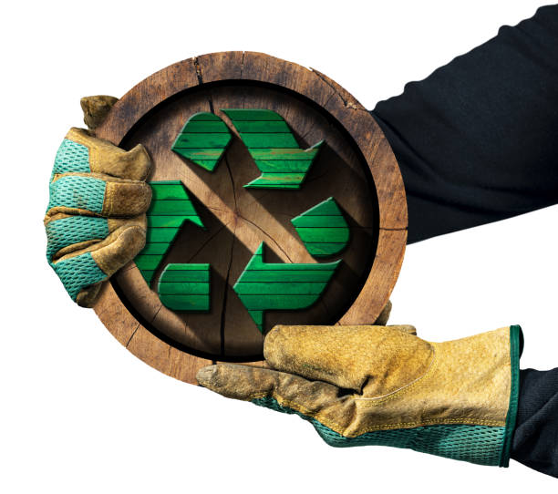 Gloved Hands Showing a Wooden Recycle Symbol - Sustainable Resources Concept stock photo