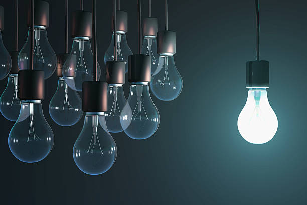 glowing bulb among the gray  intellectual property stock pictures, royalty-free photos & images