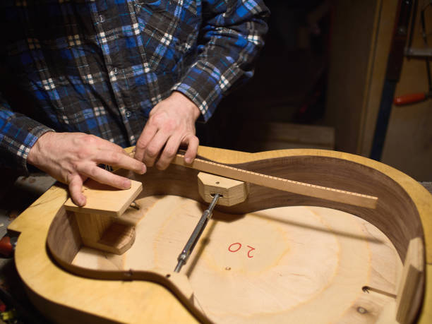 Glue lining to the side of the guitar. The process of making a classical guitar. stock photo