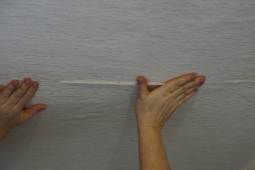 Gluing Paper Wallpaper With Hands On The Ceiling Stock Photo
