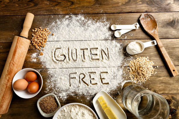 Gluten free bread ingredients and utensils on wood frame background stock photo
