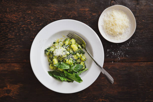 Gnocchi with spinach and parmesan stock photo
