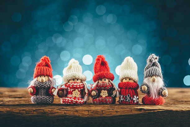 Gnomes family on wooden table on blue background stock photo
