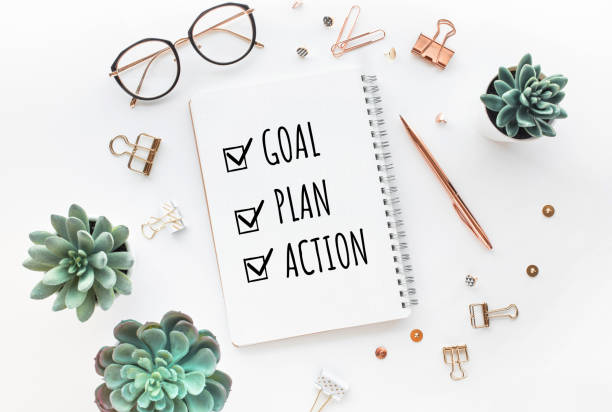 Goal,plan,action text on notepad with office accessories.Business motivation,inspiration,professional performance stock photo