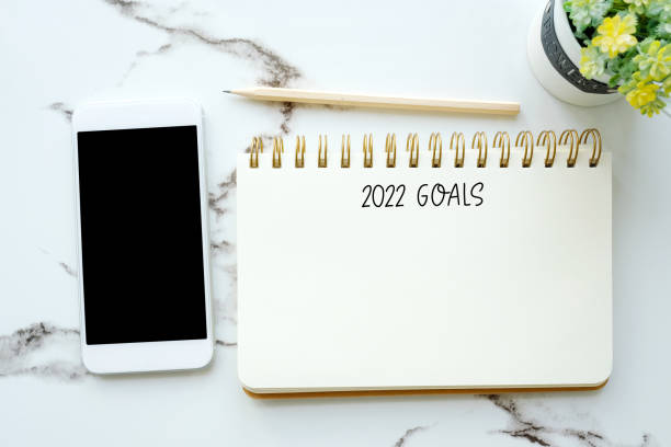 2022 goals on blank notebook paper background with copy space for text, new year aim to success in business background stock photo