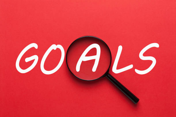 Goals with Magnifying Glass Goals written on red background and magnifying glass. Business concept arranging stock pictures, royalty-free photos & images