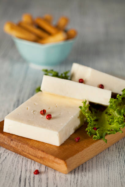 Goat cheese on cutting board stock photo