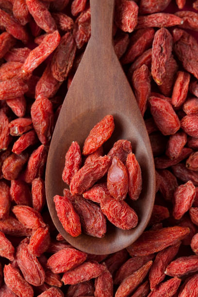 Goji berries on a wooden spoon stock photo