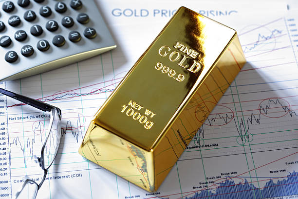 Gold bullion bar on a stocks and shares chart stock photo