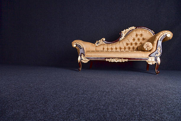 Gold Chaise Longue In A Dark Room stock photo