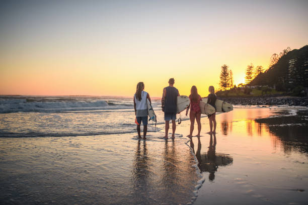 Gold Coast Surfers Checking Out Waves from Beach at Dawn stock photo
