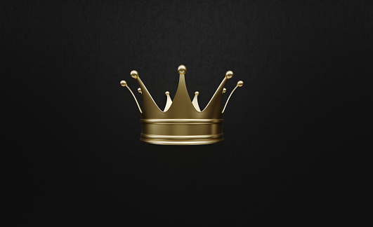 Gold crown sitting on black background. Horizontal composition with copy space. Luxury and award concept.
