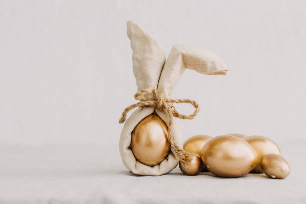Gold Easter Eggs in Natural Linen Textile. Eco Hipster Concept  easter sunday stock pictures, royalty-free photos & images
