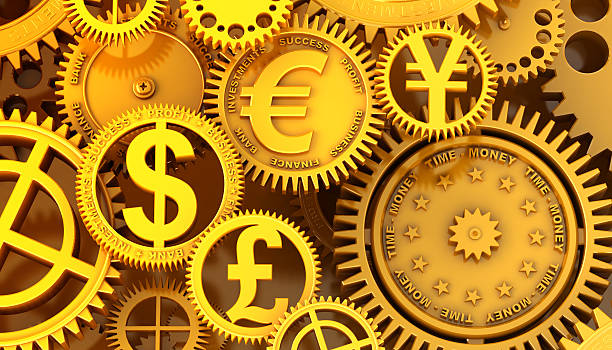 Gold gears with money symbols from different countries stock photo
