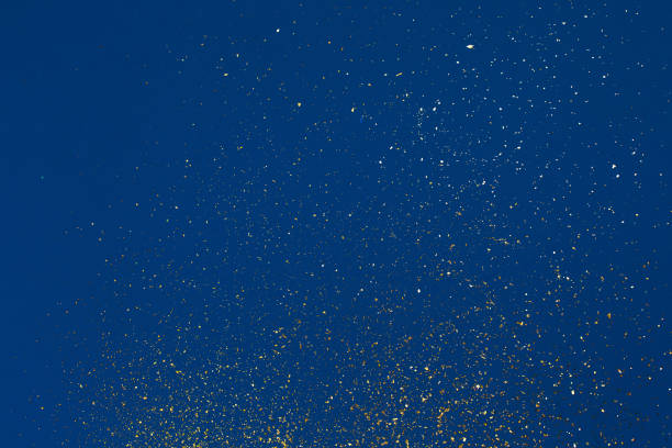 Gold glitter on blue background. Holiday abstract texture stock photo