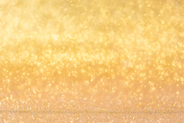 Gold lights glitter background, sparkling shiny. Christmas holiday decoration stock photo