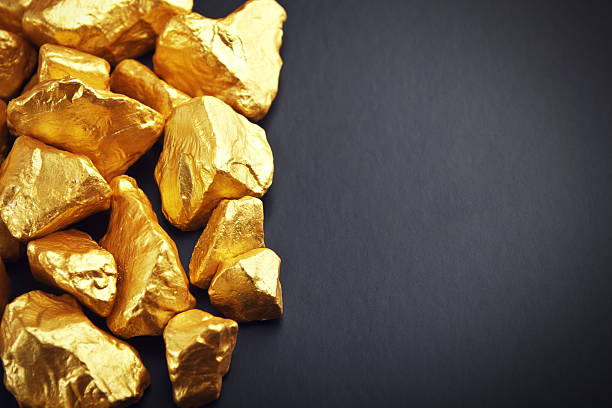 Gold nuggets on a black background. Closeup stock photo