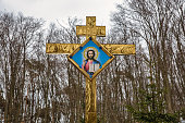 istock Gold plated religious cross in the forest. Kremenets, Ukraine. 1397967900