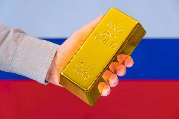 gold reserve of the russia concept. Gold bar in hand on russian flag background The gold reserve of the russia concept. Gold bar in hand on russian flag background bullion bars for sale stock pictures, royalty-free photos & images
