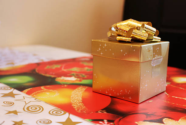 Golden christmas gift box with wrapped surprise stock photo