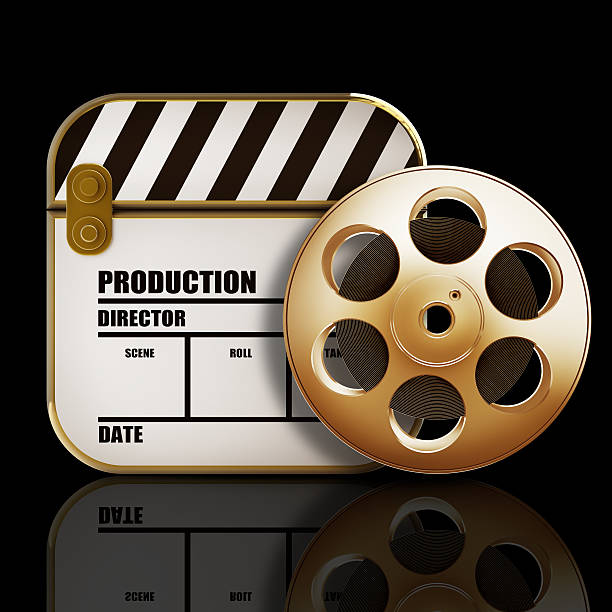 Golden Clap board and Film roll. movies symbol closeup. stock photo