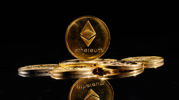 Golden coin with Ether logo. New cryptocurrency Ethereum ETH 2.0 on top of bitcoins on black background. Decentralized digital currency. Crypto payment. Electronic money Lutsk, Ukraine - May 1,2021: New cryptocurrency Ethereum ETH 2.0 on top of bitcoins on black background. Golden coin with Ether logo. Decentralized digital currency. Crypto payment. Electronic money  With Ethereum  stock pictures, royalty-free photos & images