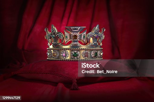 istock Golden crown on red velvet background Royal symbol, coronation. 1299447129